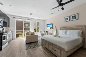 a bedroom with a large bed and a kitchen at Chic Channelside Studio | Perfect Gate Away! in Tampa