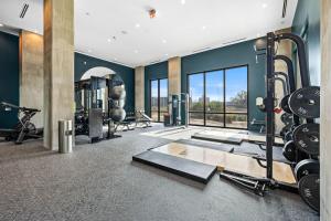 a fitness room with a gym with tread machines at Elegant 1BR Walkable to Dining, Pool + Gym in Tampa