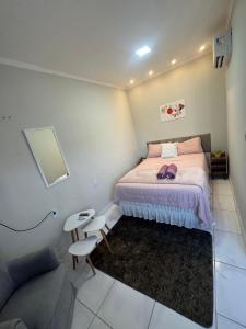 a bedroom with a bed and a chair and a couch at PNZ Loft 2 in Petrolina