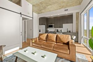 a living room with a couch and a table at 1BR Channelside | Free Amenities + Prime Location in Tampa