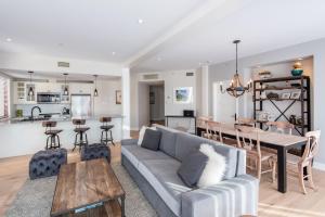 a living room with a couch and a table at Altitude Ski-in Out at Resort with Private Hottub in Mont-Tremblant