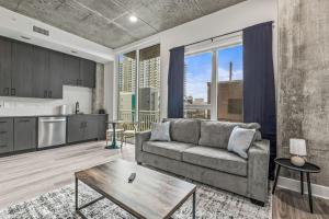 a living room with a couch and a kitchen at Chic Channelside Getaway in DT | Close to DT! in Tampa