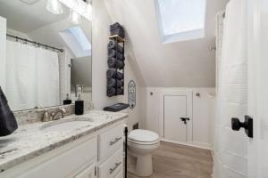 a bathroom with a sink and a toilet and a mirror at Billion Dollar Views in Winchester +71 photos