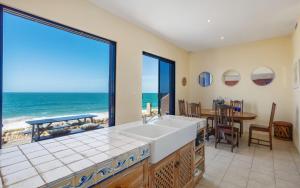 a kitchen with a view of the ocean at Casita Alegre - Clifftop Stay Above Knight Beach in Port Elliot