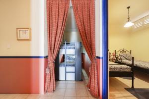 a room with a refrigerator and curtains at Casita Alegre - Clifftop Stay Above Knight Beach in Port Elliot