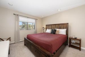 a bedroom with a large bed and a window at Comfortable Mountain Getaway near Winter Park in Fraser