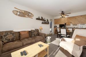a living room with a couch and a table at Comfortable Mountain Getaway near Winter Park in Fraser