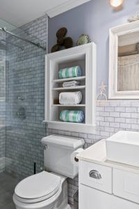 a bathroom with a white toilet and a sink at Modern Beachfront Escape - Steps from Ferry - Deck in Provincetown +40 photos