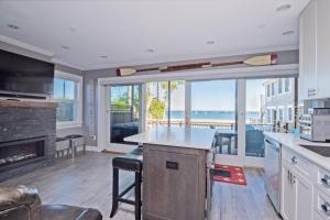 a large kitchen with a view of the ocean at Modern Beachfront Escape - Steps from Ferry - Deck in Provincetown