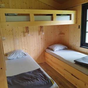 two bunk beds in a cabin with a window at ZEcamping 3 étoiles piscine chauffée in Vendoire