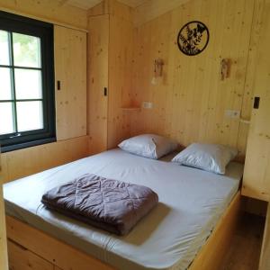 a bedroom with two beds in a log cabin at ZEcamping 3 étoiles piscine chauffée in Vendoire +77 photos