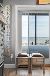 a room with a window with a view of the ocean at Modern Beachfront Escape - Steps from Ferry - Deck in Provincetown