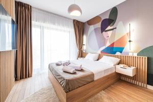 a bedroom with a bed and a large window at Best Residence - High-End Suites - by Solinis Homes in Bucharest