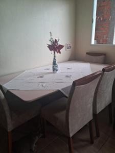 a table with a vase of flowers on top of it at Casa Torres in Torres