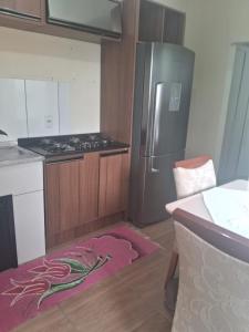a kitchen with a refrigerator and a pink rug at Casa Torres in Torres
