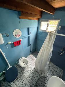 a blue bathroom with a toilet and a sink at Luna & Zoé in Barra de Valizas +73 photos