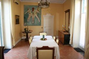 a dining room with a white table and chairs at B&B La Corte in SantʼAntimo