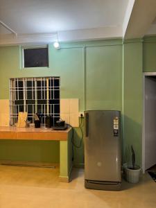 a kitchen with a counter and a stainless steel refrigerator at Humble abode Homestay 1BHK with scenic view in Itānagar +7 photos