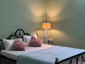 a bedroom with a bed with pink and white pillows at Humble abode Homestay 1BHK with scenic view in Itānagar
