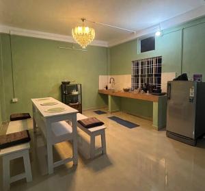 a kitchen with a table and a refrigerator at Humble abode Homestay 1BHK with scenic view in Itānagar