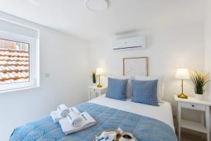 a bedroom with a bed with towels on it at Authentic Retreat by HostWise in Porto