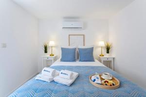a bedroom with a bed with a tray of food on it at Authentic Retreat by HostWise in Porto