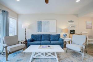 a living room with a blue couch and chairs at Pool - Ocean View - Walk to Beach - Captain Villa in Fripp Island