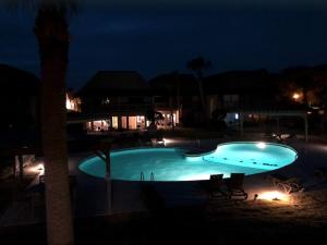 a large swimming pool at night with lights at Pool - Ocean View - Walk to Beach - Captain Villa in Fripp Island +57 photos