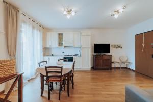 un soggiorno con tavolo e sedie e una cucina di Ohana a Montecchio Maggiore