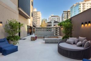 un patio con due divani su un edificio di JD Village a Itapema