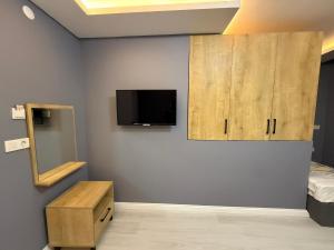 a room with a bed and a tv on a wall at Atay Apart in Istanbul