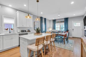 a kitchen and dining room with white cabinets and a table at 127 Fremont in Seaside Heights