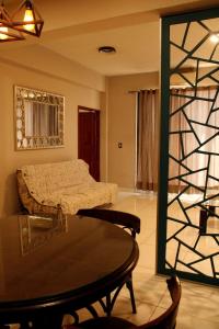 a bedroom with a bed and a table in a room at Departamento en Cuernavaca in Cuernavaca