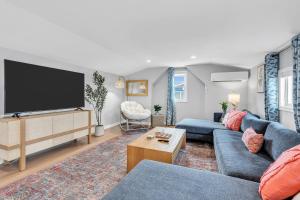 a living room with a blue couch and a flat screen tv at 127 Fremont in Seaside Heights