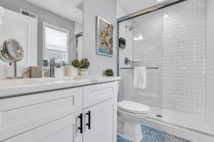 a white bathroom with a toilet and a shower at 127 Fremont in Seaside Heights +32 photos