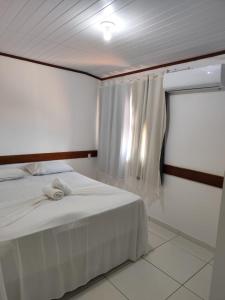 En eller flere senge i et værelse på Saudade de Morro