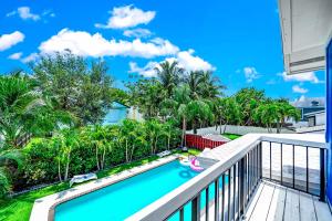 a view from the balcony of a house with a swimming pool at Sunset Haven with Saltwater Pool & mins to beach in Delray Beach