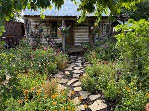 a garden in front of a house with flowers at The Karal cabin in Canterbury