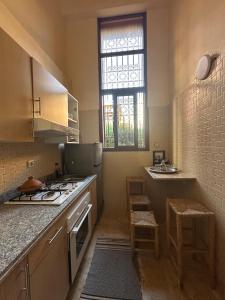 a kitchen with a stove and a sink at Gueliz Appartement in Marrakesh