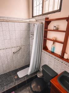 a bathroom with a shower with a toilet and a sink at Mare Mio in Puerto Baquerizo Moreno