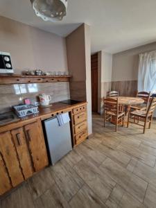a kitchen and dining room with a table and a refrigerator at Agroturystyka Natura in Pilchowice