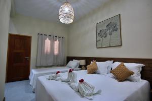 Postel nebo postele na pokoji v ubytování Pousada Jurará e Vila Jurará