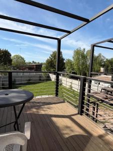 a deck with a table and a view of a field at Departamentosenchascomus in Chascomús
