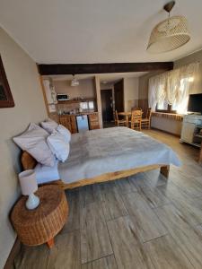 a bedroom with a large bed and a dining room at Agroturystyka Natura in Pilchowice