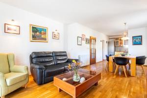 a living room with a couch and a table at Villa Dome in Slatine