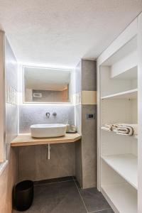 a bathroom with a sink and a mirror at Nidin Apartments in Cassano Spinola