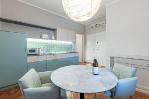 a kitchen with a table with a bottle of wine on it at Nidin Apartments in Cassano Spinola