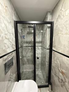 a shower with a glass door in a bathroom at Atay Apart in Istanbul