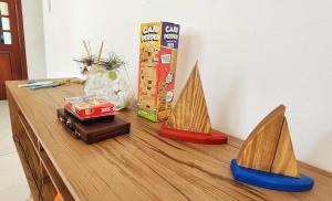 een tafel met twee houten zeilbootjes erop bij Casa Maré Floripa - Coliving, Coworking and Community in Florianópolis
