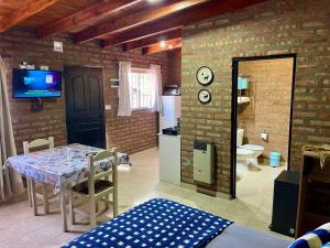 a dining room with a table and a bathroom at One Apart Mono 6 in Los Antiguos
